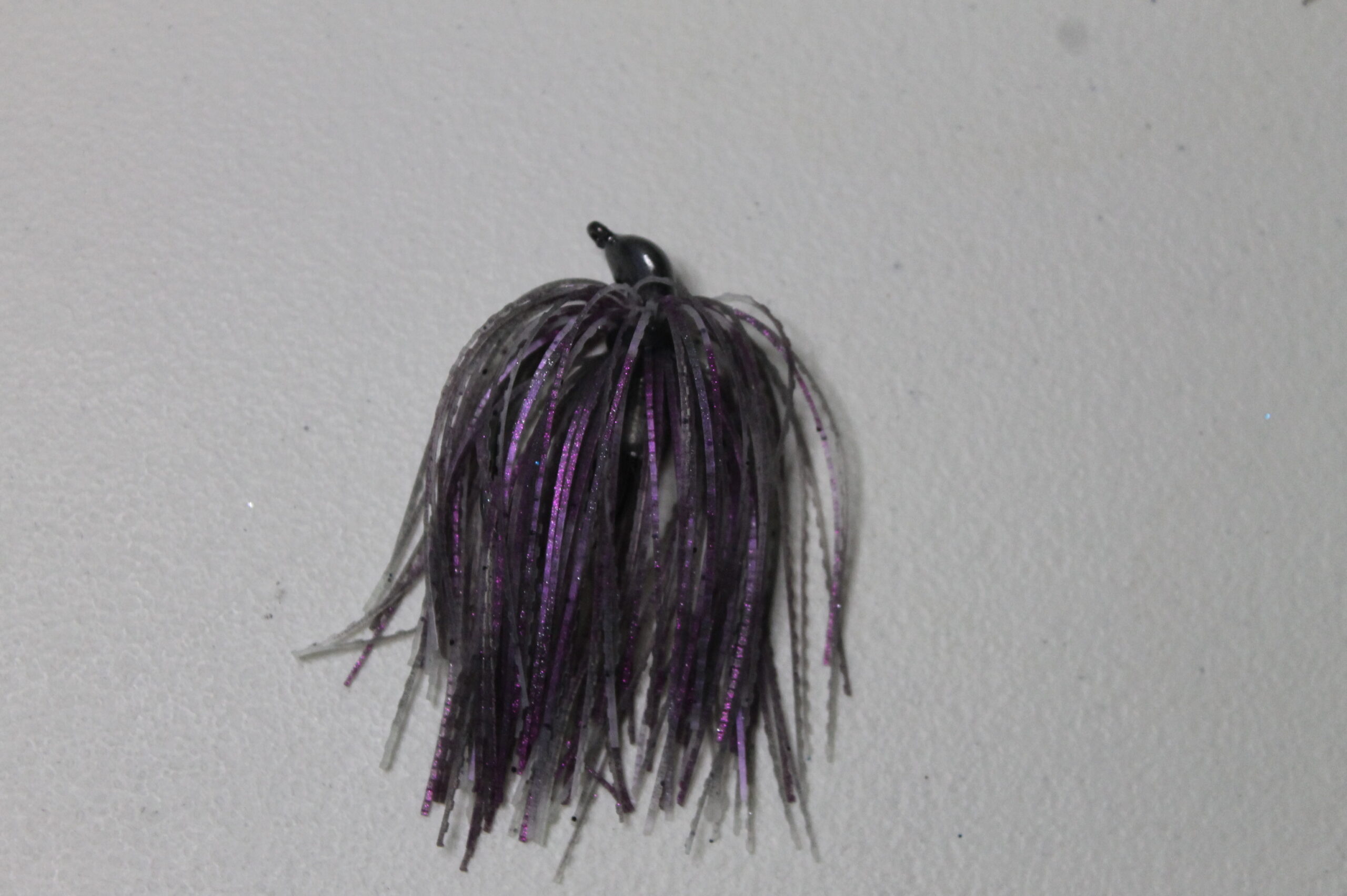 purple and black fishing swim jig